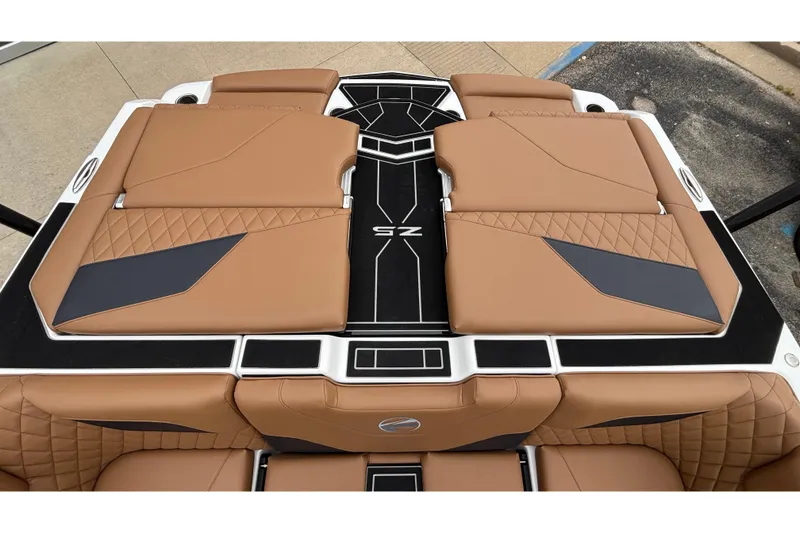 Slide: The Image of 2026 Tigé Z5 boat interior with tan and black quilted upholstery. - 11