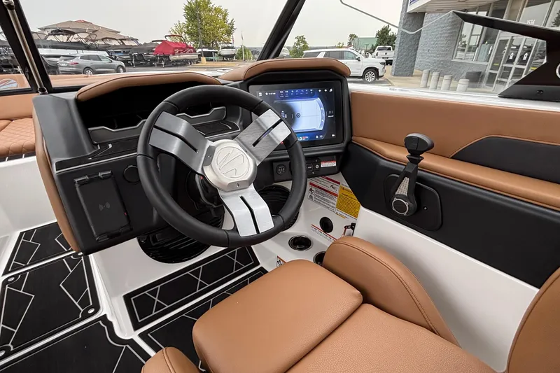 Slide: The Image of 2026 Tigé Z5 boat interior with modern steering wheel and touchscreen display. - 19
