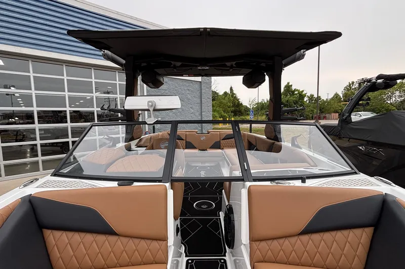 Slide: The Image of 2026 Tigé Z5 boat interior with tan diamond-stitched seats and sleek black accents. - 25