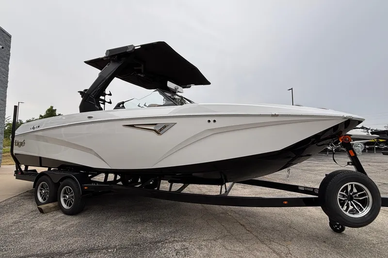 Slide: The Image of 2026 Tigé Z5 boat on trailer, sleek design, white hull, black canopy, parked outdoors. - 3