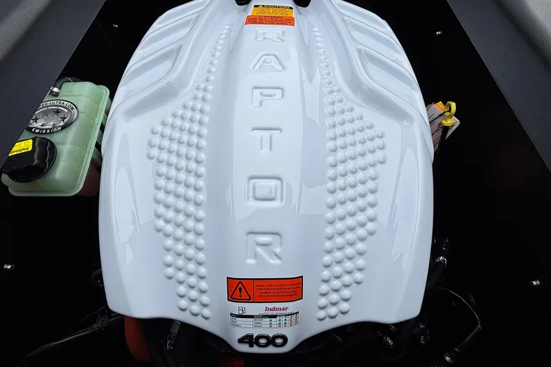 Slide: The Image of 2026 Tigé Z5 boat engine, Raptor 400, with white cover and warning labels. - 37