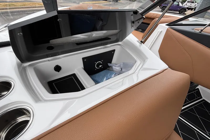 Slide: The Image of 2026 Tigé Z5 boat interior with open storage compartment and tan seating. - 38