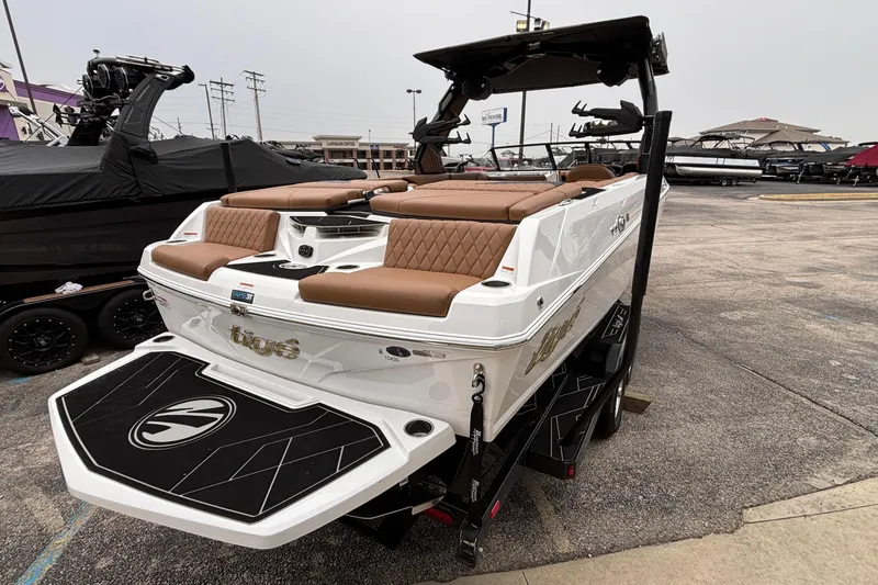 Slide: The Image of 2026 Tigé Z5 boat with brown seating, displayed on a trailer in a parking lot. - 4