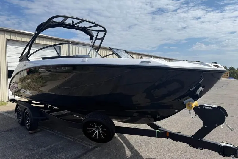 Slide: The Image of 2026 Yamaha Boats AR250 on trailer, sleek black design, parked outdoors. - 3