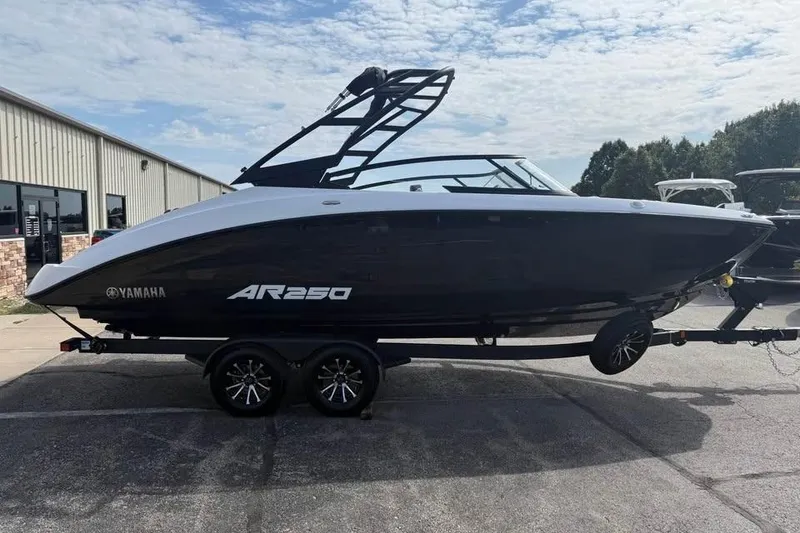 Slide: The Image of 2026 Yamaha Boats AR250 on trailer, parked outdoors near a building. - 4