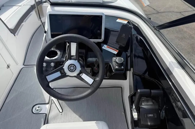 Slide: The Image of 2026 Yamaha Boats AR250 helm with steering wheel, touchscreen, and controls. - 9