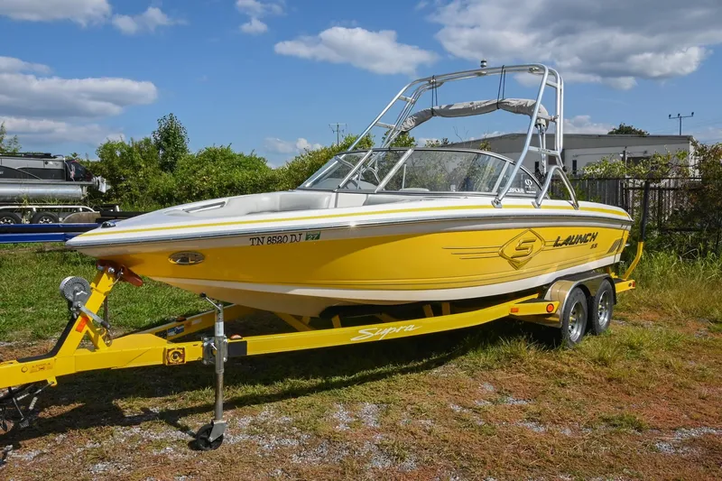 Slide: The Image of 2004 Supra Launch SS boat in vibrant yellow on a matching trailer. - 1