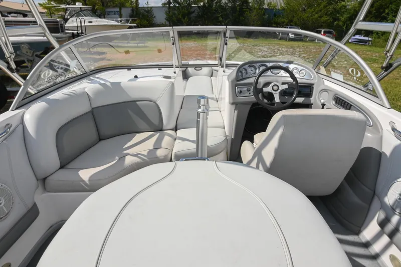 Slide: The Image of 2004 Supra Launch SS boat interior with white seating and steering console. - 11