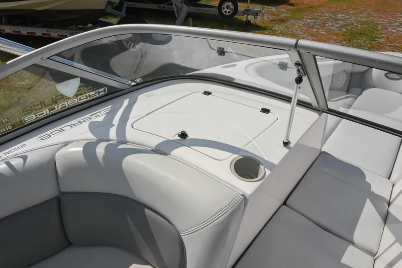 Slide: The Image of 2004 Supra Launch SS boat interior with white seating and windshield. - 13