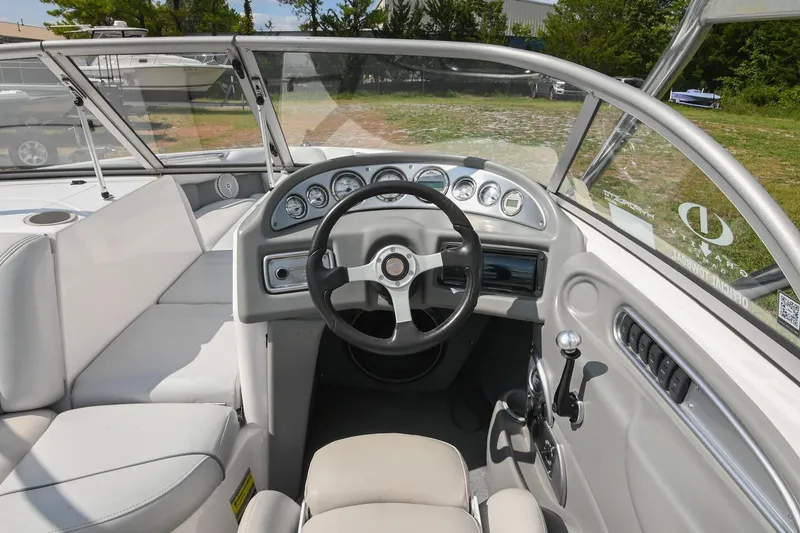 Slide: The Image of 2004 Supra Launch SS boat interior with steering wheel and dashboard controls. - 16