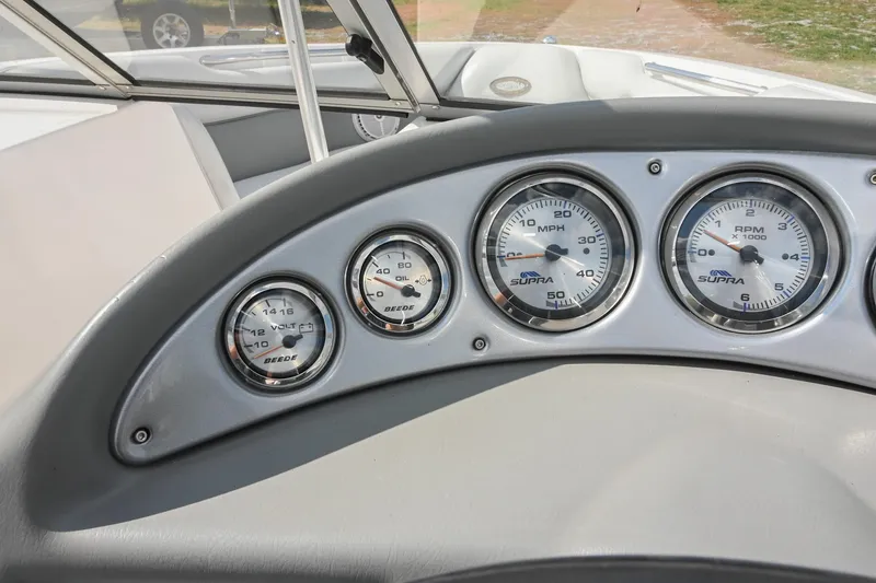 Slide: The Image of Dashboard of a 2004 Supra Launch SS boat with speedometer and gauges. - 18