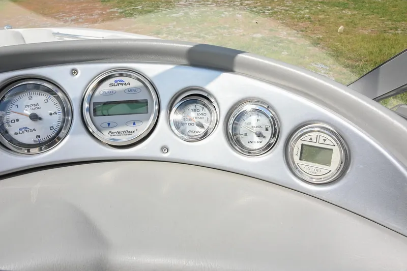 Slide: The Image of Dashboard of a 2004 Supra Launch SS boat with various gauges and controls. - 20