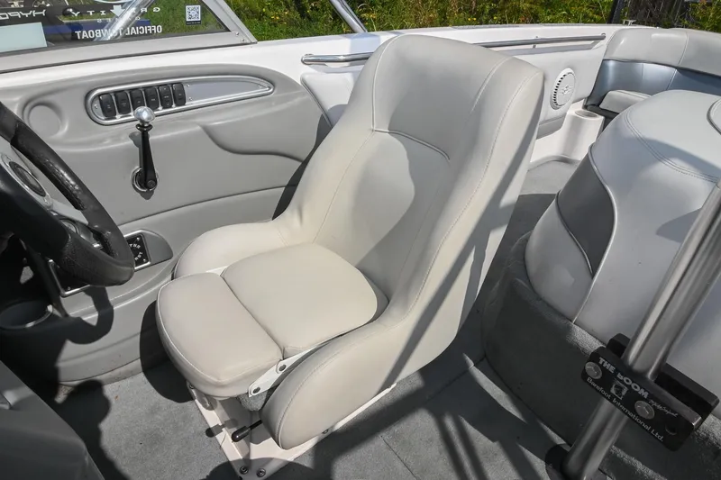 Slide: The Image of 2004 Supra Launch SS boat interior with white seating and steering wheel. - 21