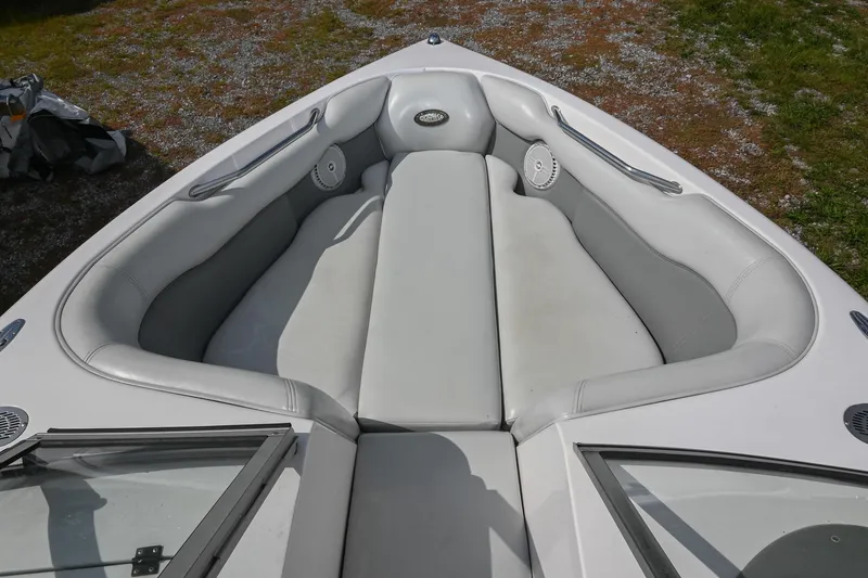 Slide: The Image of 2004 Supra Launch SS boat interior with white cushioned seating and speakers. - 23