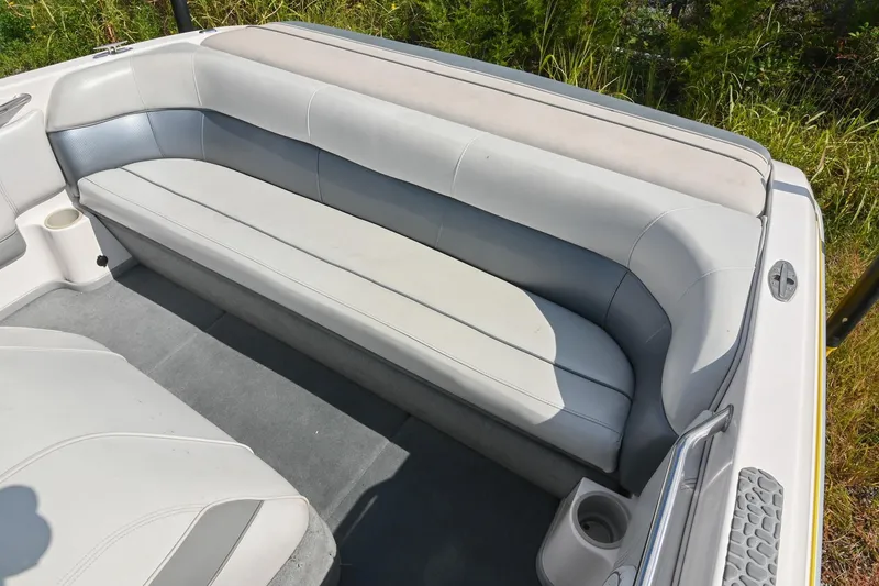 Slide: The Image of 2004 Supra Launch SS boat interior with gray seating and cup holders. - 8