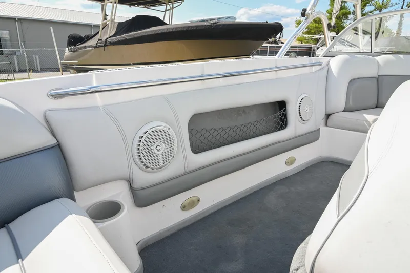Slide: The Image of 2004 Supra Launch SS boat interior with white seating and built-in speakers. - 9