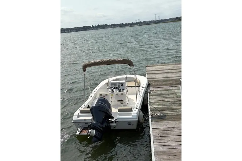 Slide: The Image of 2022 Tidewater 180 CC Adventure boat docked on calm water. - 2