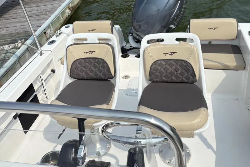 Slide: The Image of 2022 Tidewater 180 CC Adventure boat interior with dual seats and steering wheel. - 8