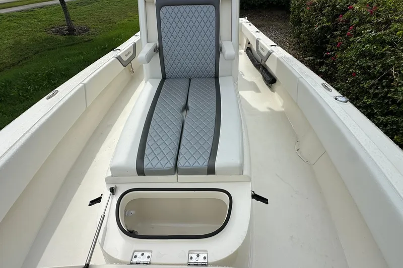 Slide: The Image of 2026 ShearWater 270 SS Open boat interior with cushioned seating and storage compartment. - 13