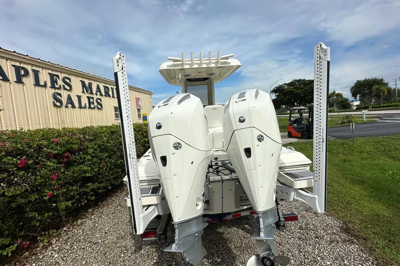 Slide: The Image of 2026 ShearWater 270 SS Open boat with dual engines at a marine sales location. - 2