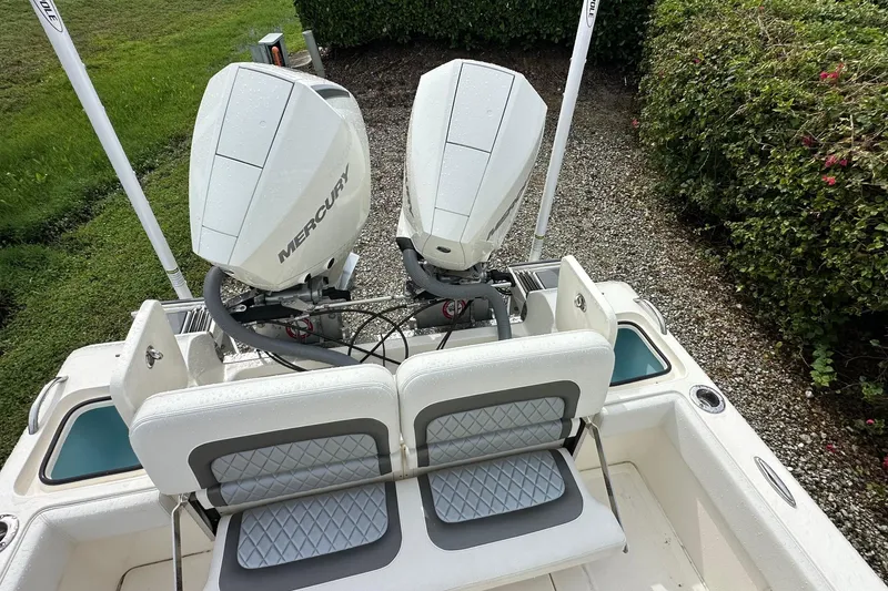 Slide: The Image of 2026 ShearWater 270 SS Open boat with dual Mercury engines, rear seating, and lush surroundings. - 22