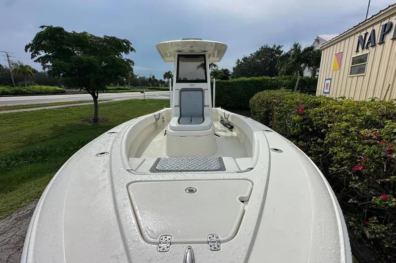 Slide: The Image of 2026 ShearWater 270 SS Open boat, sleek design, parked outdoors near greenery. - 6