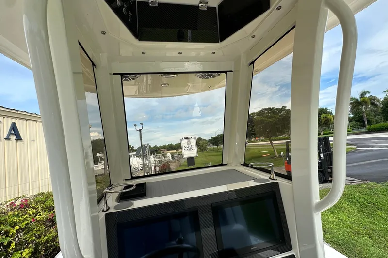 Slide: The Image of Interior view of 2026 ShearWater 270 SS Open boat, showcasing helm and navigation screens. - 8