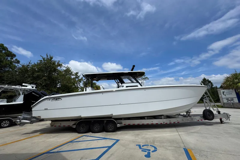 Slide: The Image of 2026 Invincible 40 Catamaran on trailer under clear blue sky. - 10