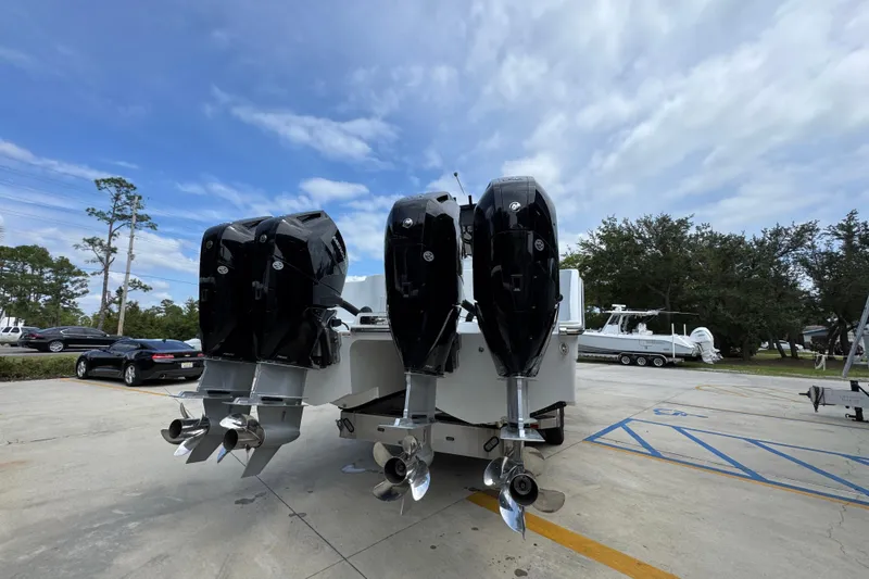 Slide: The Image of 2026 Invincible 40 Catamaran with four powerful outboard engines in a parking lot. - 14