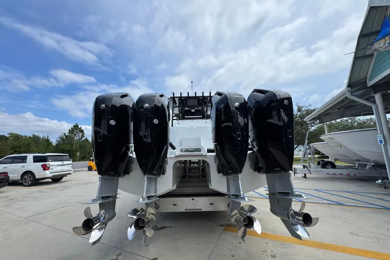 Slide: The Image of 2026 Invincible 40 Catamaran with four powerful outboard engines, parked outdoors. - 15