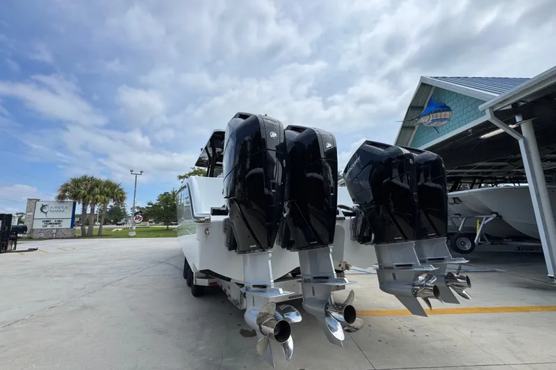 Slide: The Image of 2026 Invincible 40 Catamaran with powerful outboard engines at a marina. - 16