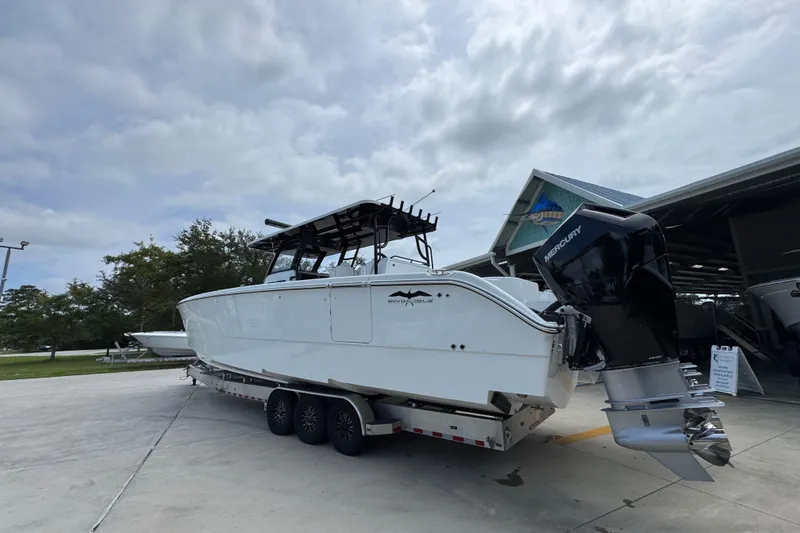 Slide: The Image of 2026 Invincible 40 Catamaran on trailer, featuring powerful Mercury outboard engines. - 17