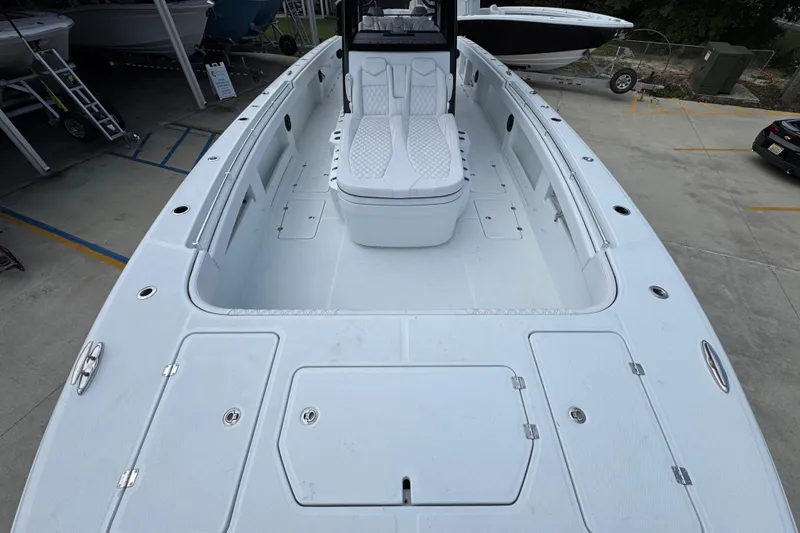 Slide: The Image of 2026 Invincible 40 Catamaran with spacious deck and seating, docked at marina. - 19