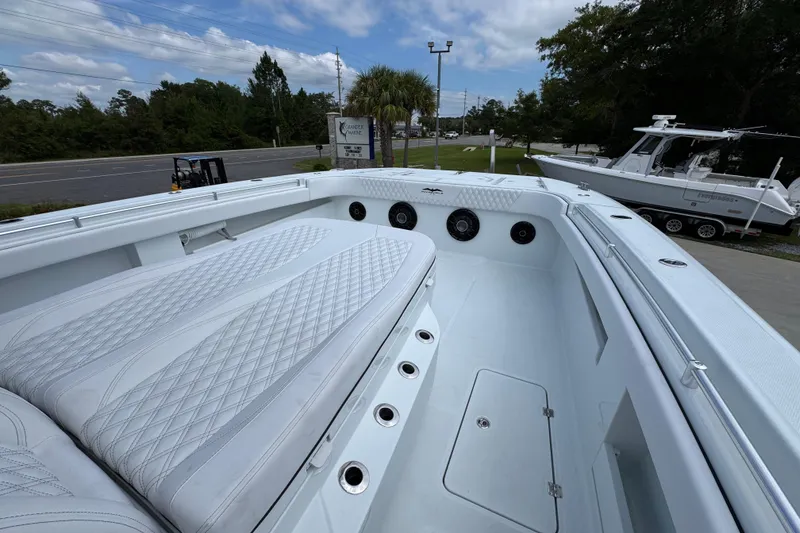 Slide: The Image of Invincible 40 Catamaran 2026 with luxurious seating and sleek design on display outdoors. - 22