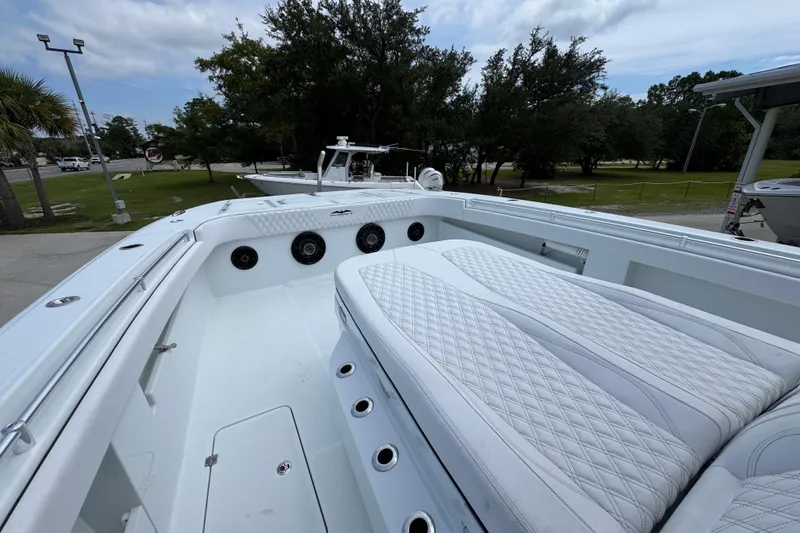 Slide: The Image of 2026 Invincible 40 Catamaran with luxurious seating and sleek design in a marina setting. - 24