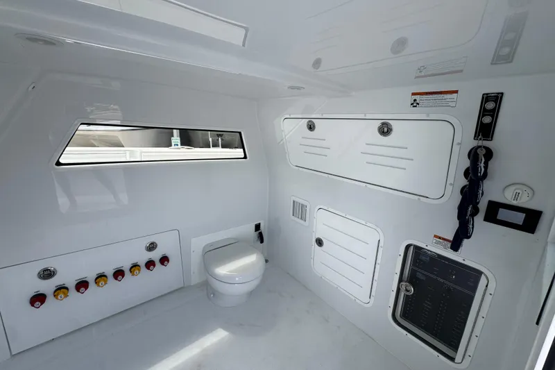 Slide: The Image of Invincible 40 Catamaran 2026 interior with modern controls and compact toilet area. - 28