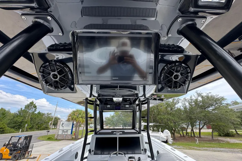 Slide: The Image of 2026 Invincible 40 Catamaran dashboard with Garmin display and speakers, outdoor setting. - 39