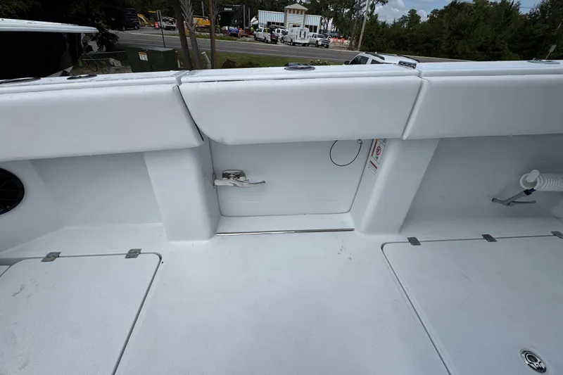 Slide: The Image of 2026 Invincible 40 Catamaran deck with storage compartments and seating area. - 40