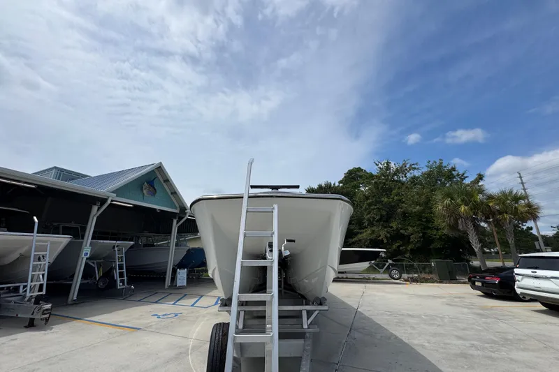 Slide: The Image of 2026 Invincible 40 Catamaran on trailer under clear sky, parked near trees and buildings. - 6