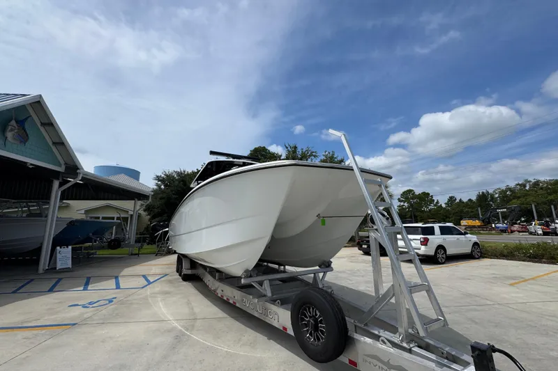 Slide: The Image of 2026 Invincible 40 Catamaran on trailer, parked outdoors under a clear sky. - 7