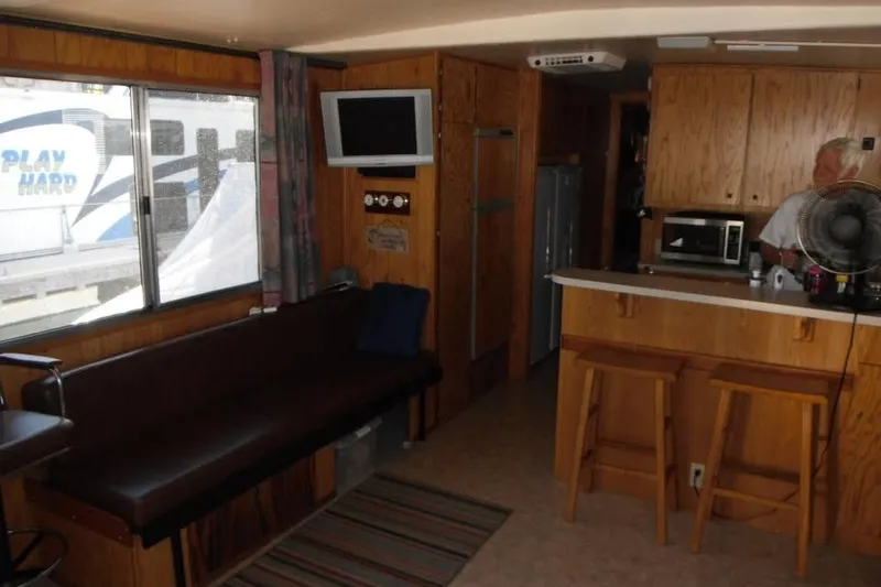 The Image of Interior of 1985 Boatel Hercules Custom with wood paneling and modern amenities. - 1