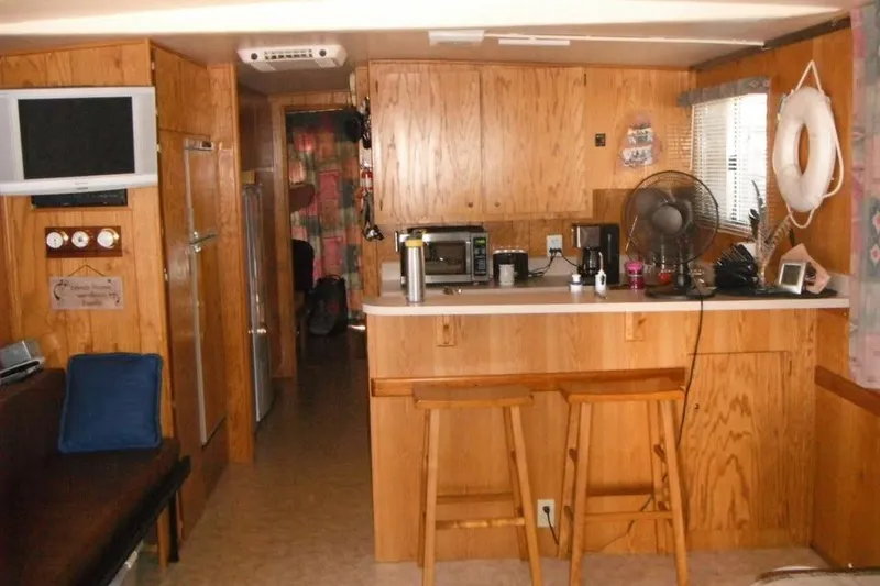 Slide: The Image of 1985 Boatel Hercules Custom interior with wooden cabinetry and kitchen area. - 10