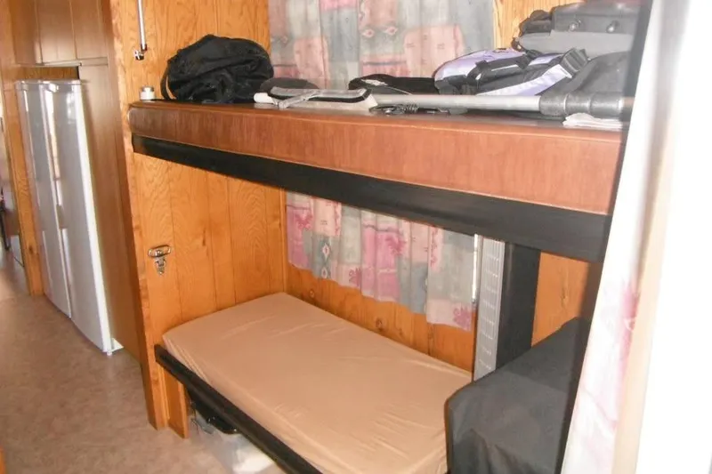 Slide: The Image of Interior of 1985 Boatel Hercules Custom with bunk beds and storage. - 7