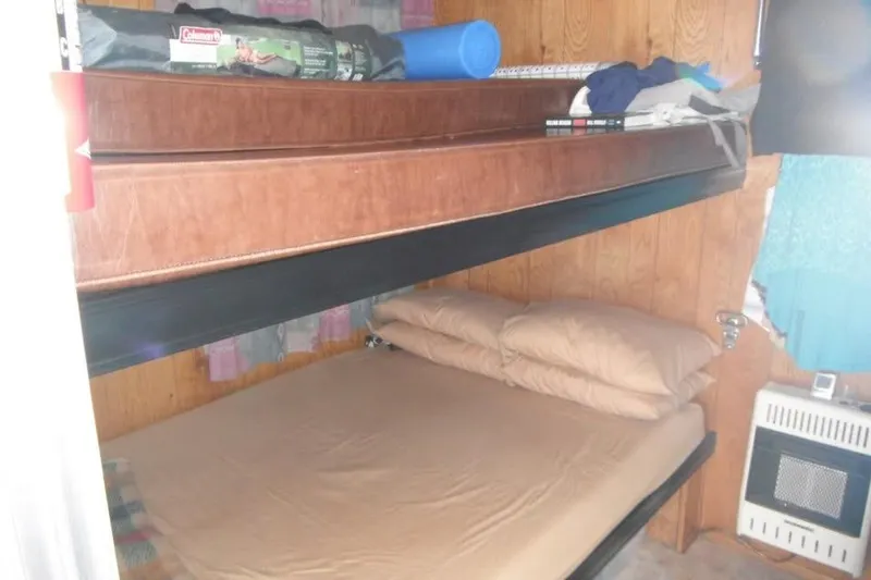 Slide: The Image of Interior of 1985 Boatel Hercules Custom with bunk beds and wood paneling. - 9