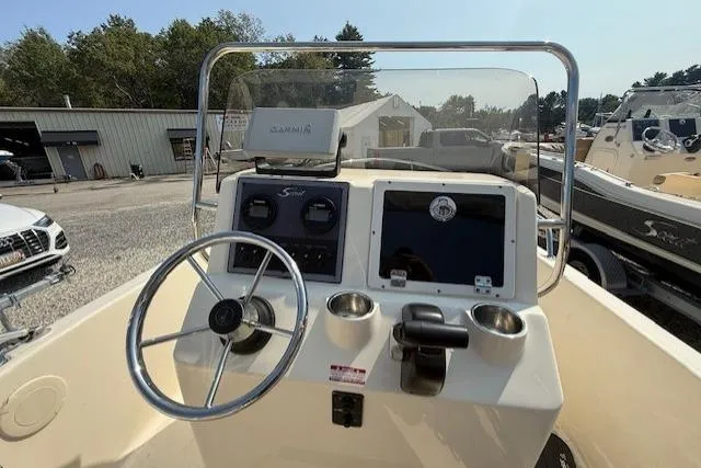 Slide: The Image of 2016 Scout 175 Sportfish boat dashboard with steering wheel and navigation equipment. - 3