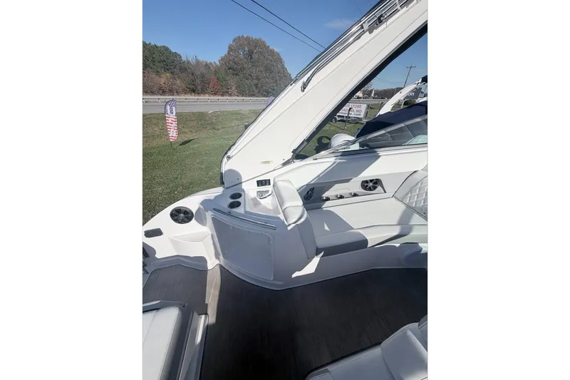 Slide: The Image of 2019 Regal 28 Express boat interior with white seating and control panel. - 15