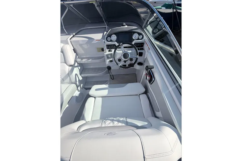 Slide: The Image of 2019 Regal 28 Express boat interior with steering wheel and seating. - 18