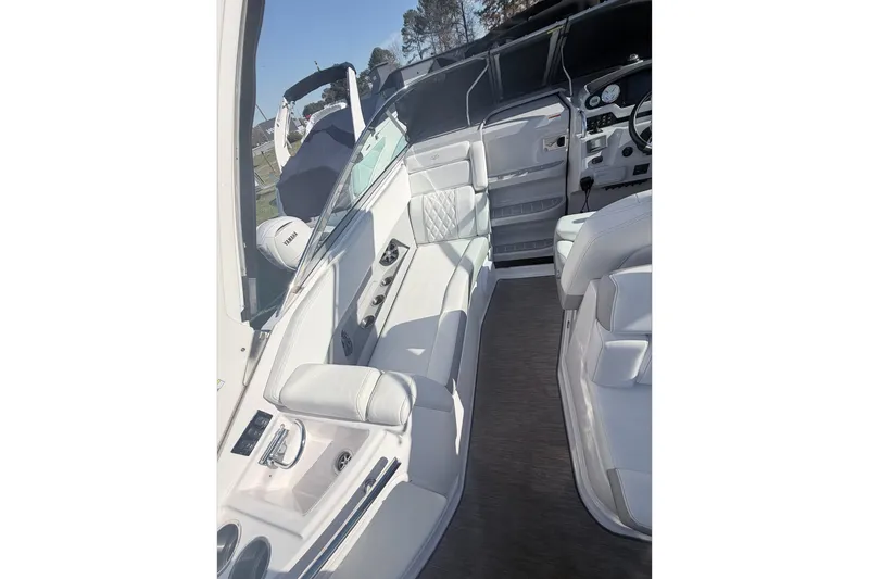 Slide: The Image of 2019 Regal 28 Express boat interior with white seating and modern dashboard. - 19