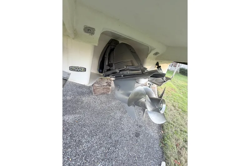 Slide: The Image of 2019 Regal 28 Express boat propeller and stern drive on gravel surface. - 28