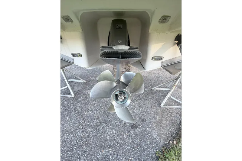Slide: The Image of 2019 Regal 28 Express boat propeller and stern view on gravel surface. - 29